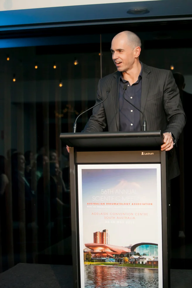 Samuel Whittle speaking at a lectern